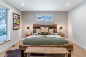 a bedroom with a large bed and a table at Whitefish Suncrest Charm- Newly Build Modern Townhouse w Pool Table andPet Friendly! in Whitefish