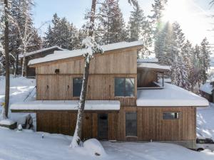 a cabin in the woods in the snow at Whitefish Suncrest Charm- Newly Build Modern Townhouse w Pool Table andPet Friendly! in Whitefish