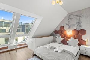 a bedroom with a bed and a large window at Designer Apartments Asaria in Vienna