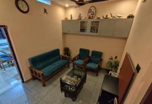 sala de estar con 2 sillas y mesa en Sree Nivas Homestay, en Trivandrum