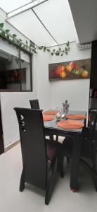 uma sala de jantar com uma mesa preta e cadeiras em Apartamento completo cerca a embajada 1 em Bogotá