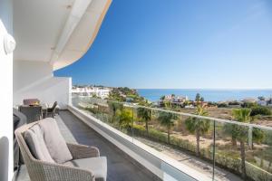 a balcony with chairs and a view of the ocean at Casa Chloe Luxury Ocean View Apartment in Lagos