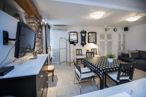 a living room with a dining table and a living room at Apartment Art in Rovinj