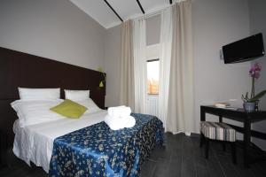 Un pat sau paturi într-o cameră la Hotel Felice