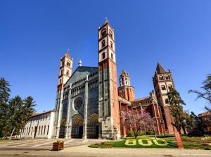 a large building with a clock tower on top of it at Loft Piazza Cavour Vercelli in Vercelli