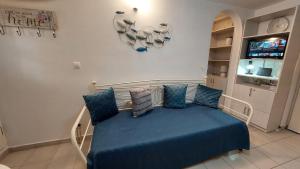 a bedroom with a bed with blue sheets and pillows at Belva Blue Naxos Stylish, Naxos Town, near Beach in Naxos Chora