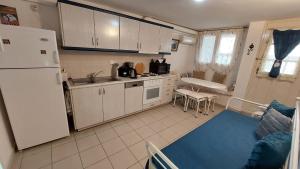 a kitchen with a white refrigerator and a table at Belva Blue Naxos Stylish, Naxos Town, near Beach in Naxos Chora