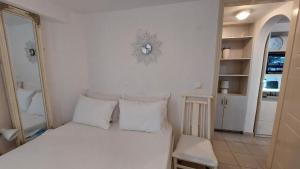 a bedroom with a white bed with white pillows at Belva Blue Naxos Stylish, Naxos Town, near Beach in Naxos Chora