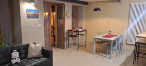 a living room with a couch and a table with stools at B&B Casa V-Ale in Collegno +21 photos