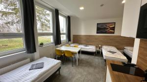 a room with two beds and a table at Hotel Hangar in Mošnov