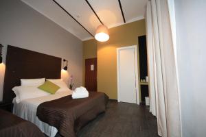 Postel nebo postele na pokoji v ubytování Hotel Felice