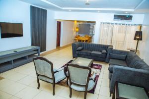a living room with a couch and a tv at Urban View Lodge - Apt.5 Room 1 in Abuja