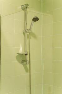 a shower with a shower head in a bathroom at Spacious Apartment in Belém in Lisbon