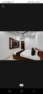 a picture of a bedroom with a bed and a tv at Star inn hotel in Lucknow