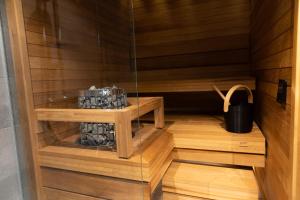 a sauna with wooden floors and a glass wall at Levi Cranberry in Sirkka