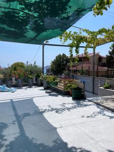 a patio with potted plants and a building at Spyros Apartment in Paleo Tsifliki