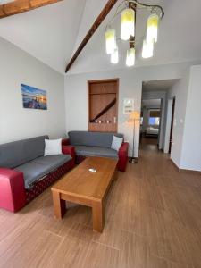 a living room with a couch and a coffee table at Spyros Apartment in Paleo Tsifliki