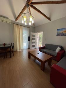 a living room with a couch and a table at Spyros Apartment in Paleo Tsifliki