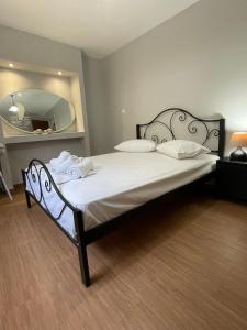 a bedroom with a large bed with a large mirror at Spyros Apartment in Paleo Tsifliki