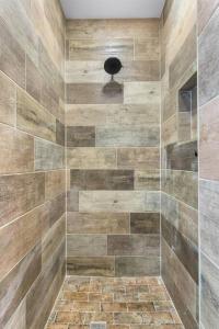 a bathroom with a shower with a glass door at Stockyards 5 mins!-New!-Sleeps 8. Cowboy Bungalow in Fort Worth +36 photos