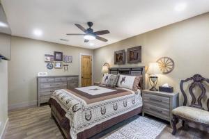 a bedroom with a bed and a ceiling fan at Stockyards 5 mins!-New!-Sleeps 8. Cowboy Bungalow in Fort Worth