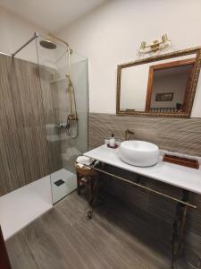 a bathroom with a sink and a shower at La Posada de Bayuela in Castillo de Bayuela