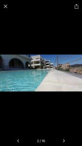 a picture of a swimming pool with a building at Domu sa luna mia in Villasimius