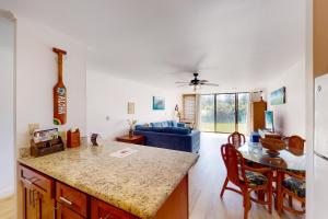 a kitchen and living room with a couch and a table at Turtle Bay Resort 166 in Kahuku