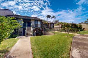 a house with a lawn and a sidewalk at Turtle Bay Resort 166 in Kahuku
