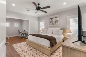 a bedroom with a bed and a ceiling fan at Take It Easy - 104 Gould Street in King City +29 photos