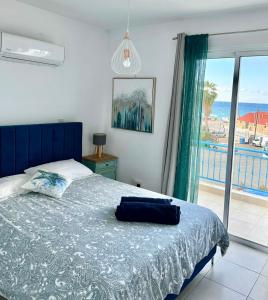 a bedroom with a bed and a view of the ocean at Blue Lagoon Latsi Centre in Lachi