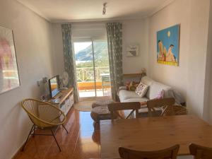 a living room with a table and a couch at Cala Reona Holiday Apartment in Cabo de Palos