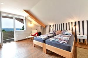 a bedroom with a bed and a large window at House Bela vido in Drežnik Grad