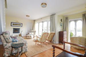 a living room with a couch and chairs at Condurro House in Truro