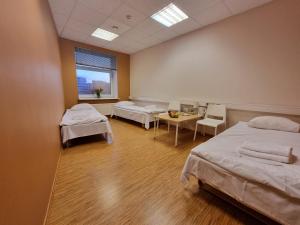 a hospital room with two beds and a table at Room near City Center Harbour in Tallinn +22 photos