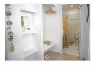 a white bathroom with a toilet and a sink at Athos Mare Holiday Studios in Pefkochori +37 photos