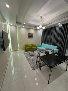 a living room with a couch and a table at Lovely High Quality Self Check-in Apartments شقق سلام بالدخول الذاتي in Al Madinah