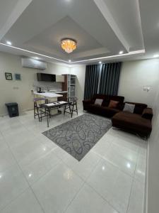 a living room with a couch and a table at Lovely High Quality Self Check-in Apartments شقق سلام بالدخول الذاتي in Medina