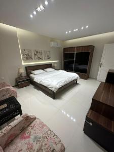 a large bedroom with a bed and a fireplace at Lovely High Quality Self Check-in Apartments شقق سلام بالدخول الذاتي in Medina