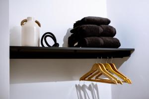 a shelf with a stack of towels and scissors at Skegness Luxury 2 bedroom apartment , sleeps 6 people in Lincolnshire