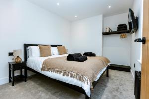 a bedroom with a bed and a tv on a wall at Skegness Luxury 2 bedroom apartment , sleeps 6 people in Lincolnshire