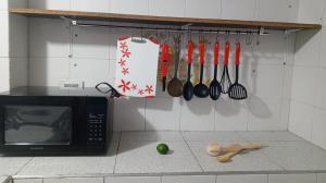 a kitchen with a counter with a microwave and utensils at Cali Sur Centrar Apto 2 - Somos Pet Friendly in Cali