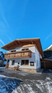 a house with a balcony on top of it at Ferienwohnung Lech'tl in Steeg