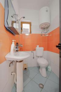 a bathroom with a sink and a toilet at Friends Villa in Sarandë