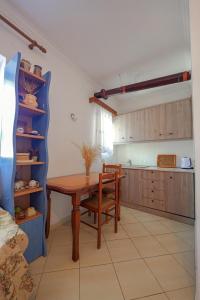 a kitchen with a wooden table and a dining room at Friends Villa in Sarandë