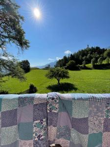 a quilt on a fence with a view of a field at Plasur - Apartement Bella Vista in Montechiaro