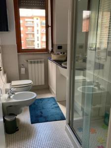 a bathroom with a toilet and a glass shower at La casa del Parco di San Donato Milanese in San Giuliano Milanese