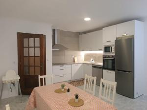 kuchnia ze stołem i lodówką w obiekcie Vivienda en el casco histórico de Baiona w mieście Baiona +34 zdjęcia