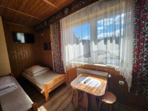 a small room with a bed and a window at Willa u Renaty - Widok na Giewont in Zakopane