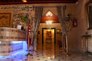 a hallway in a building with flags on the floor at Hotel DONIA in Hammam-Plage